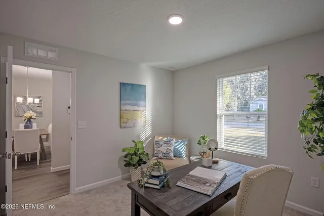 a dining room with furniture and window