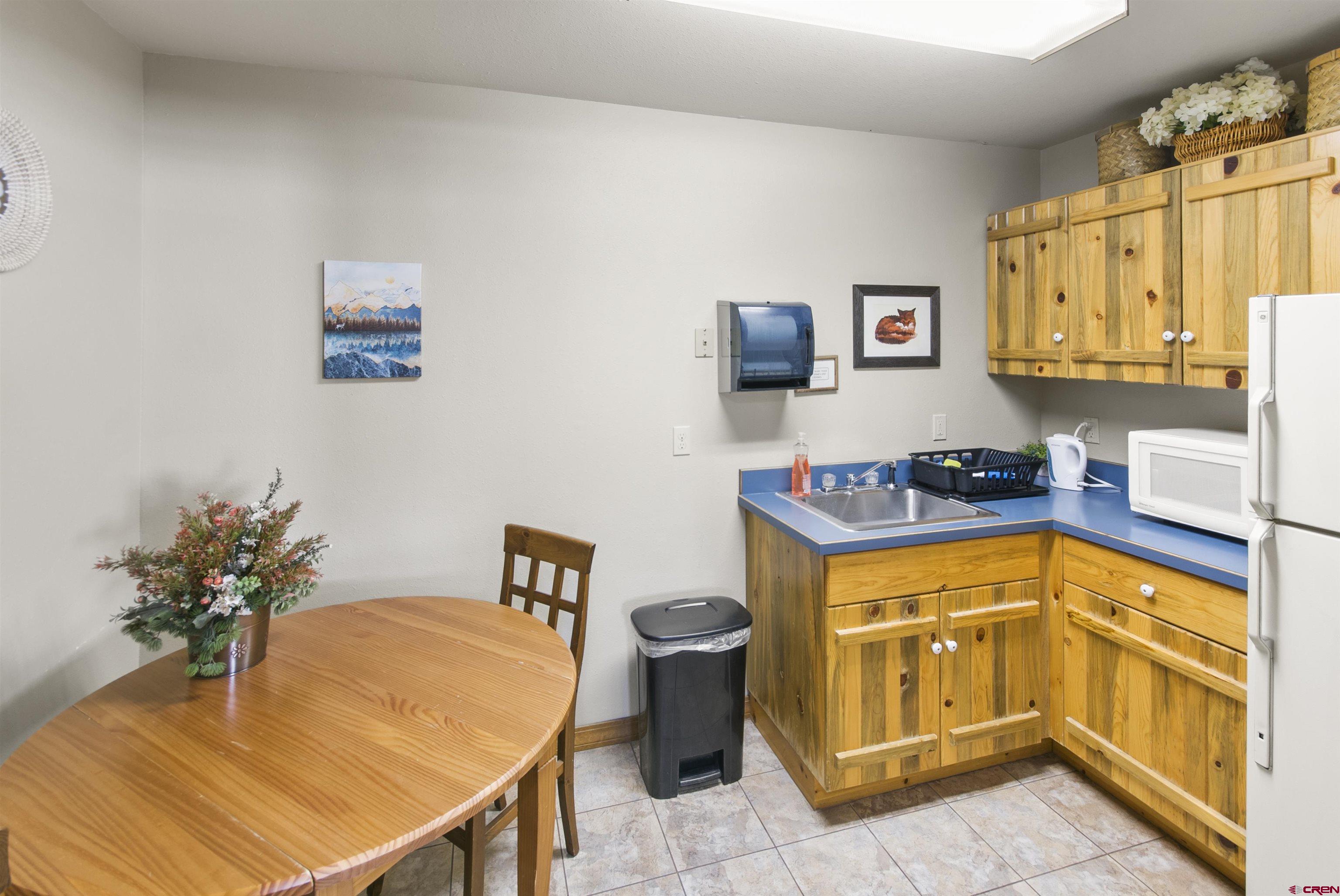 112 Village Square West Ridgway, CO 81432 - Photo 14 of 16 a kitchen with stainless steel appliances granite countertop a sink a stove and a refrigerator