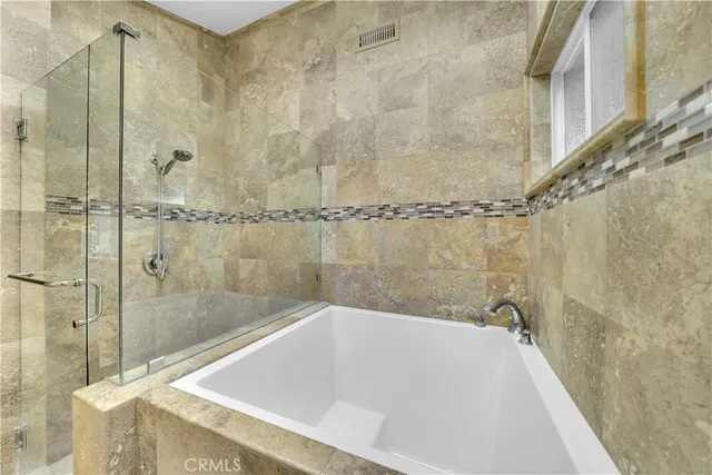 a bath tub sitting next to a shower