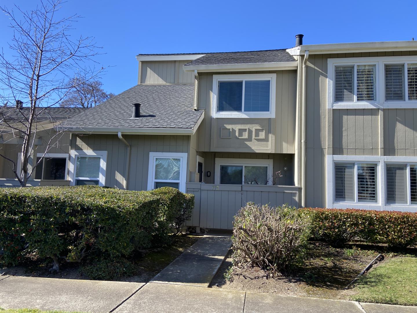 a front view of a house with a garden