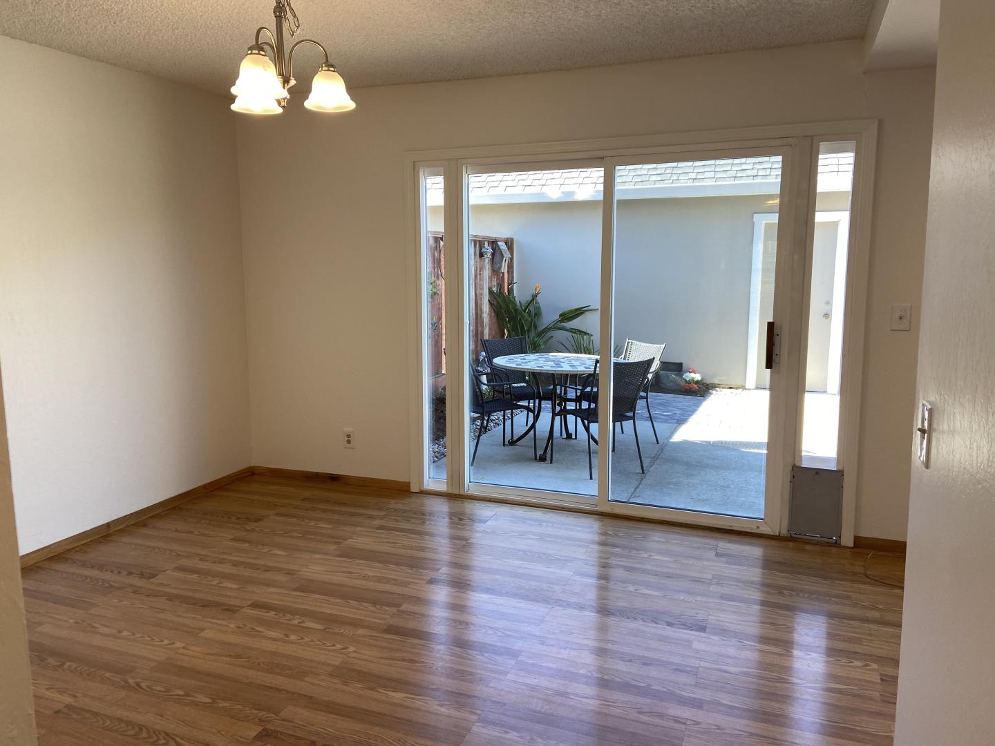 715 Comet Drive Foster City, CA 94404 - Photo 12 of 25 a view of a dining room with furniture a chandelier and wooden floor