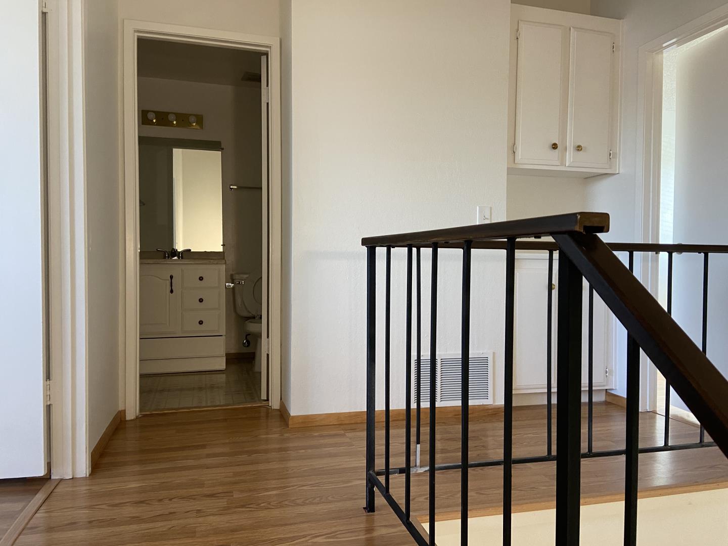 715 Comet Drive Foster City, CA 94404 - Photo 13 of 25 a view of a hallway with wooden floor and staircase