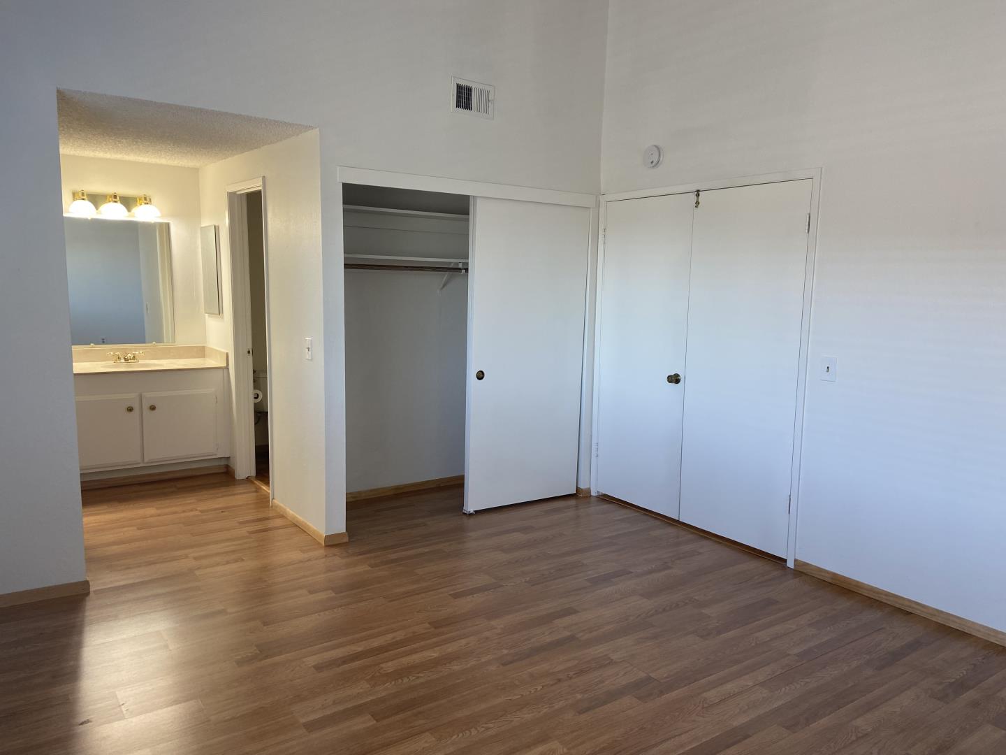 715 Comet Drive Foster City, CA 94404 - Photo 15 of 25 a view of an empty room with wooden floor and a bathroom
