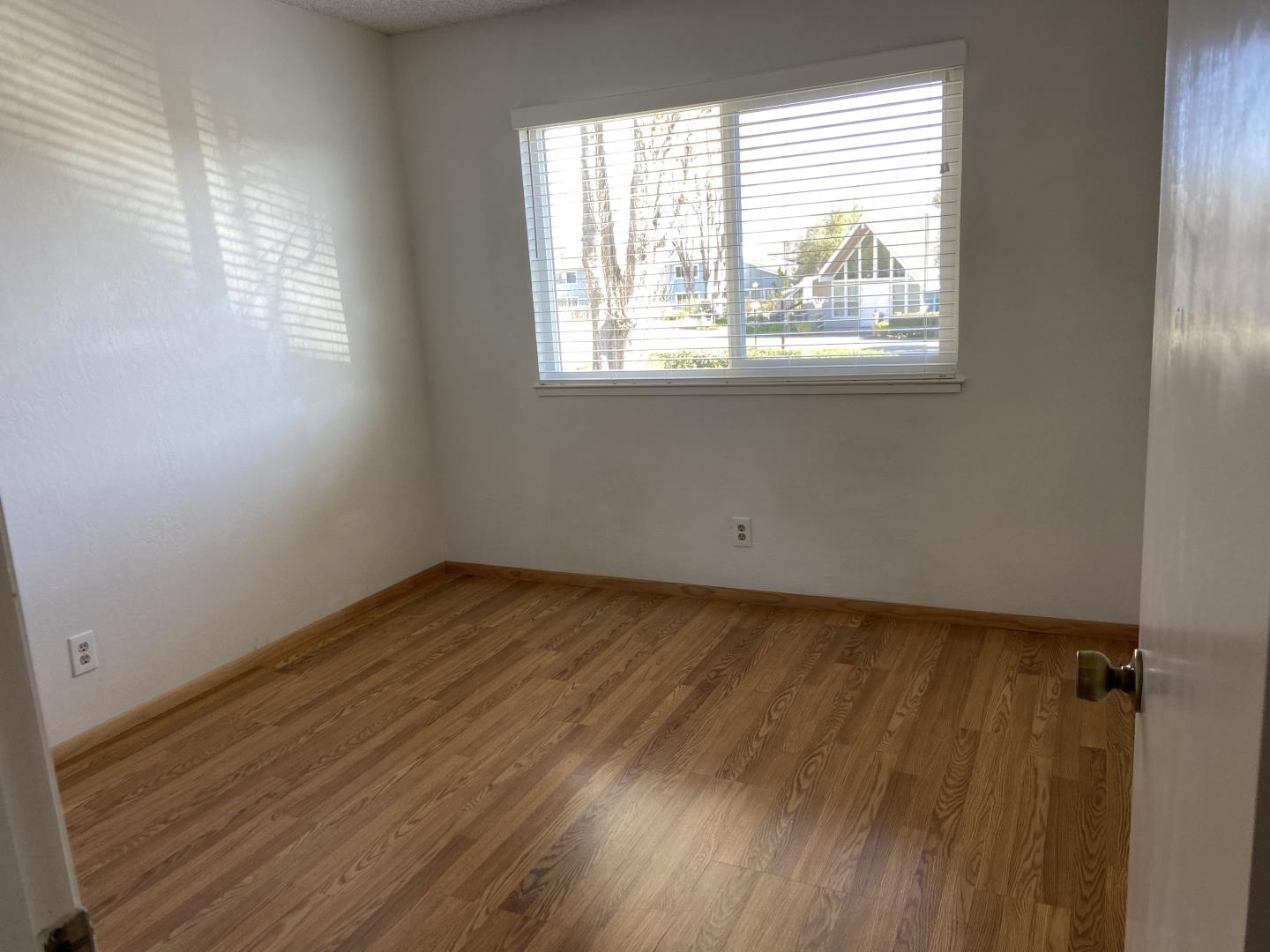 715 Comet Drive Foster City, CA 94404 - Photo 18 of 25 an empty room with wooden floor and windows