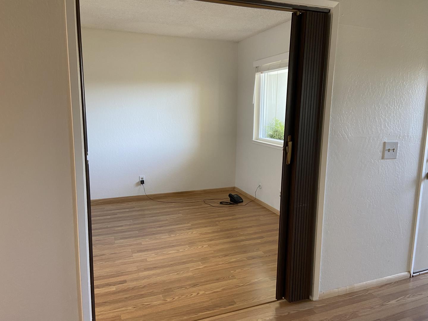 715 Comet Drive Foster City, CA 94404 - Photo 5 of 25 a view of a room with wooden floor and cabinet