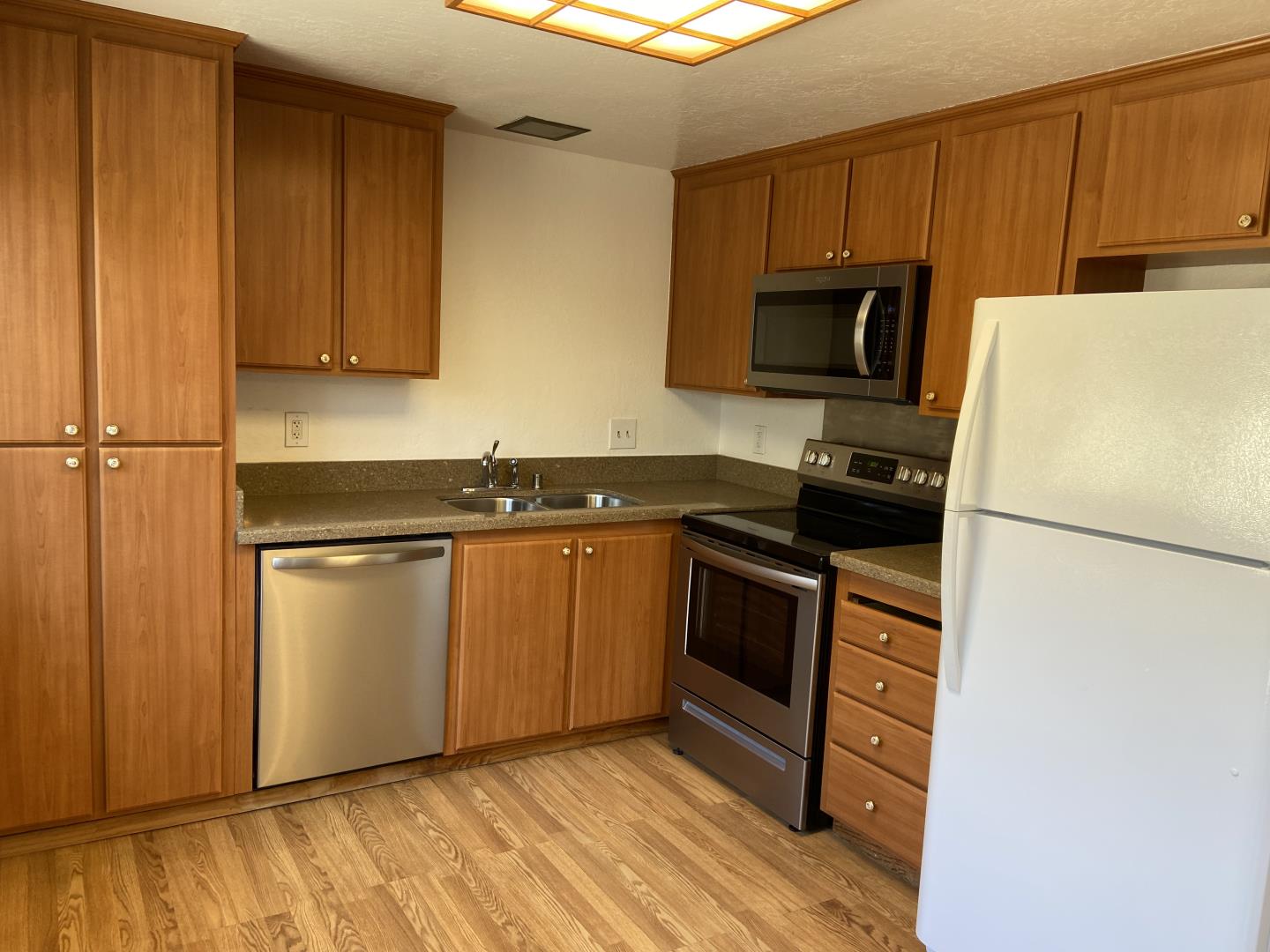 715 Comet Drive Foster City, CA 94404 - Photo 9 of 25 a kitchen with a sink a refrigerator and cabinets