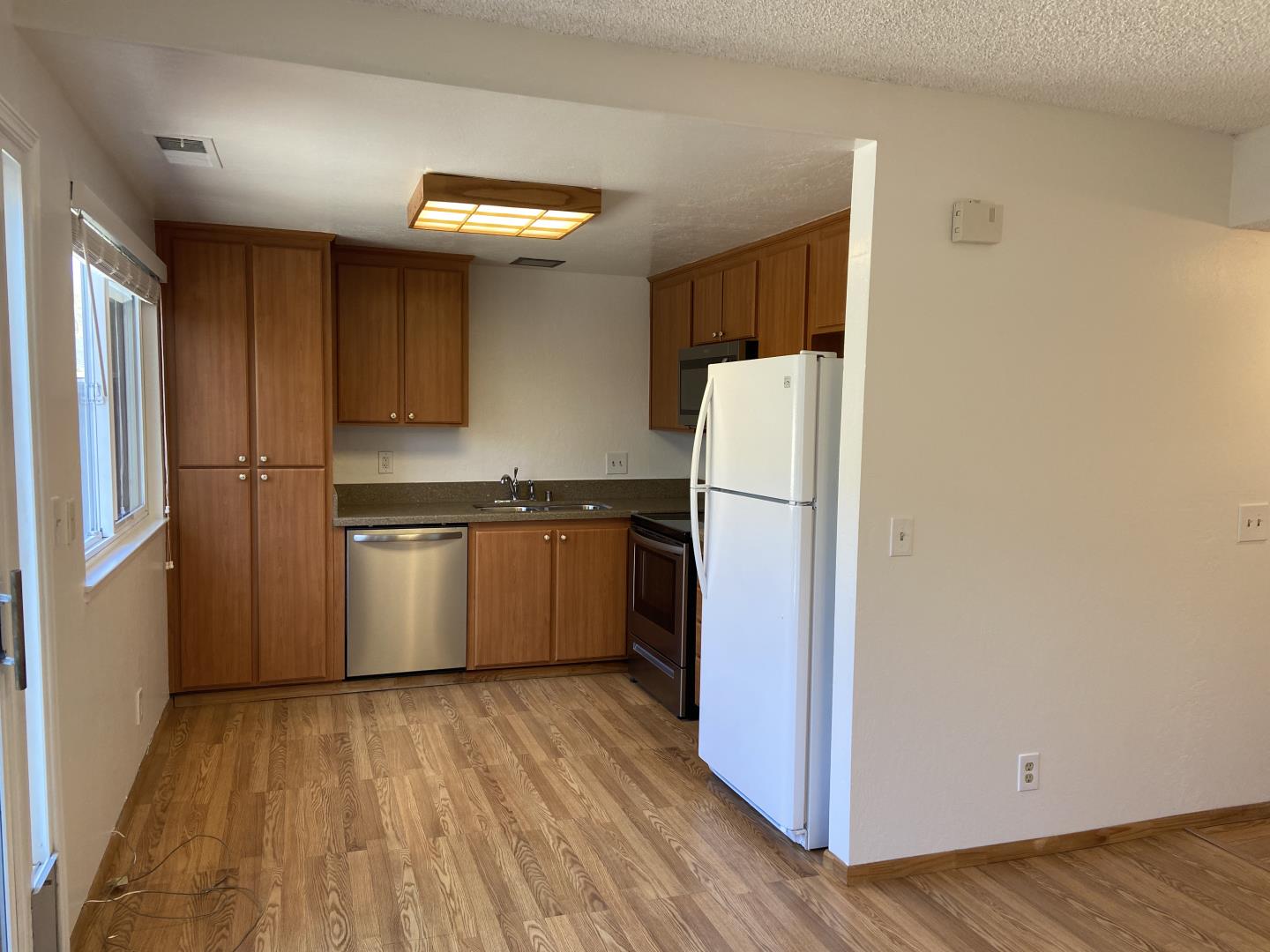 715 Comet Drive Foster City, CA 94404 - Photo 10 of 25 a kitchen with a refrigerator and a stove