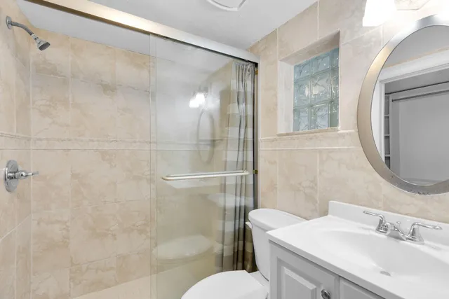 a bathroom with a sink toilet and shower