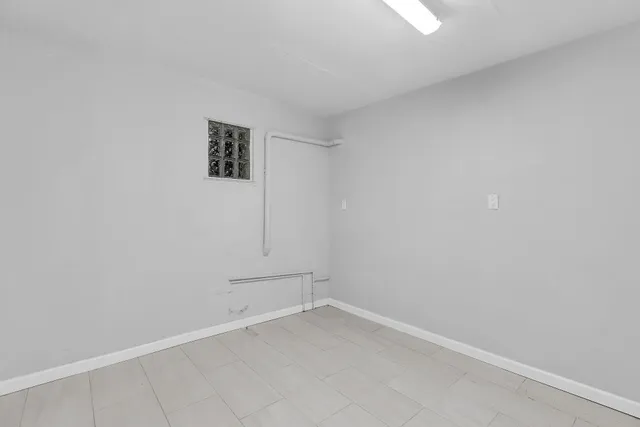 a view of kitchen with furniture and refrigerator