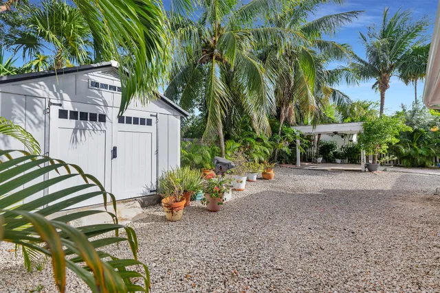a view of a house with a yard and tree s