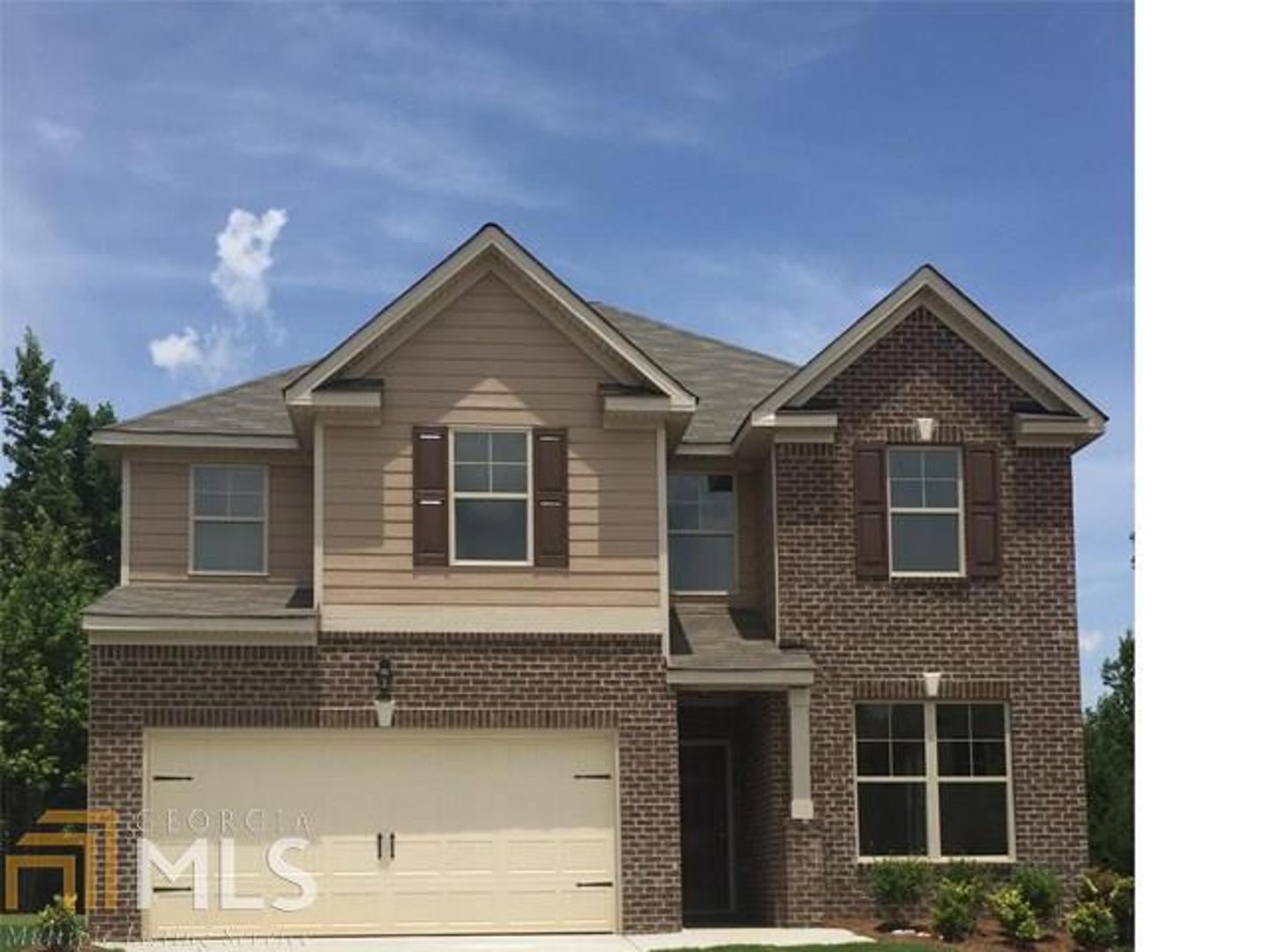 5822 Savannah River Road, Unit 82 Atlanta, GA 30349 - Photo 1 of 1 a front view of a house with a yard and garage