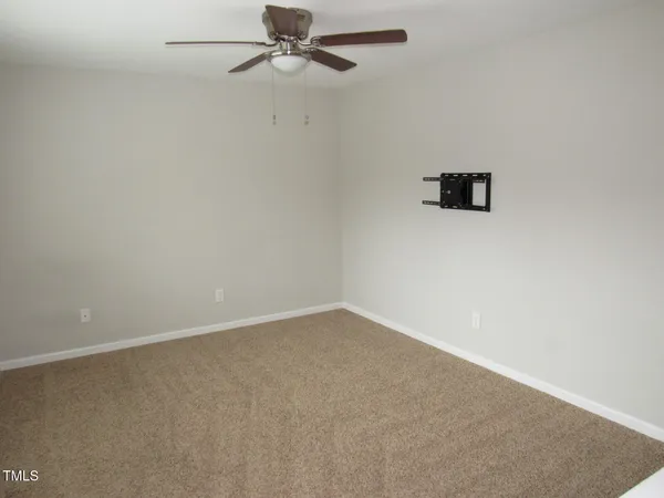 a large bed sitting in a bedroom next to a window