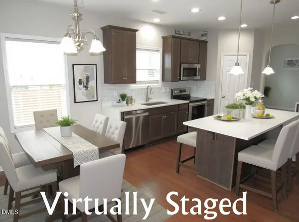 a kitchen with a dining table chairs and sink
