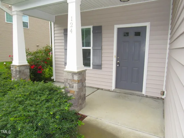 front view of the house with potted plants