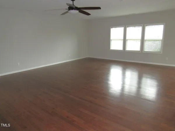 a view of a kitchen with a dining table chairs and a floor to ceiling window
