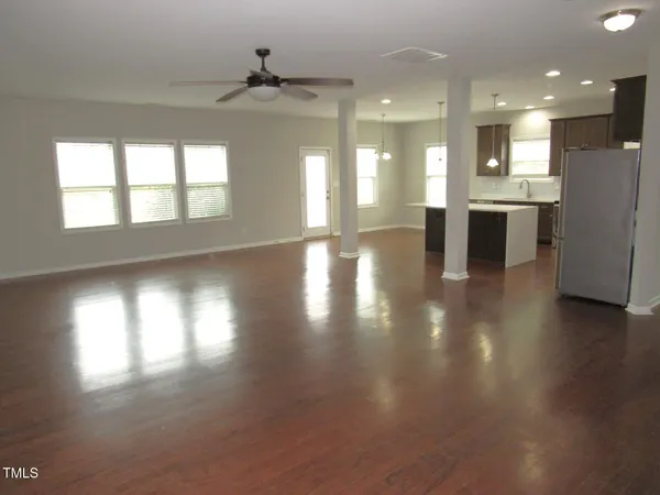 a view of a kitchen with a sink and a refrigerator