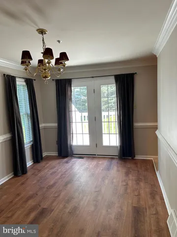 a view of a room with a window and wooden floor
