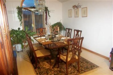 8799 Calhoun Place Crown Point, IN 46307 - Photo 8 of 10 a view of a dining room with furniture and wooden floor