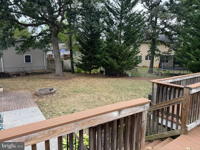 a utility room with stainless steel appliances wooden cabinet and a sink