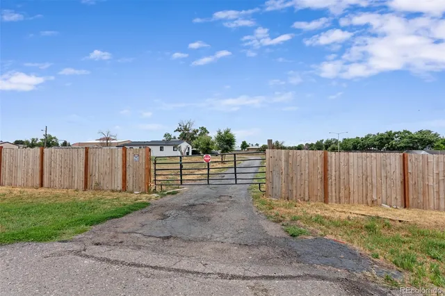 a view of a backyard with wooden fence