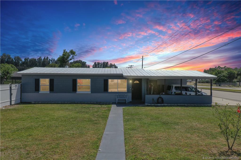 2409 Elizabeth Avenue Fort Pierce, FL 34981 - Photo 1 of 30 a front view of a house with a yard