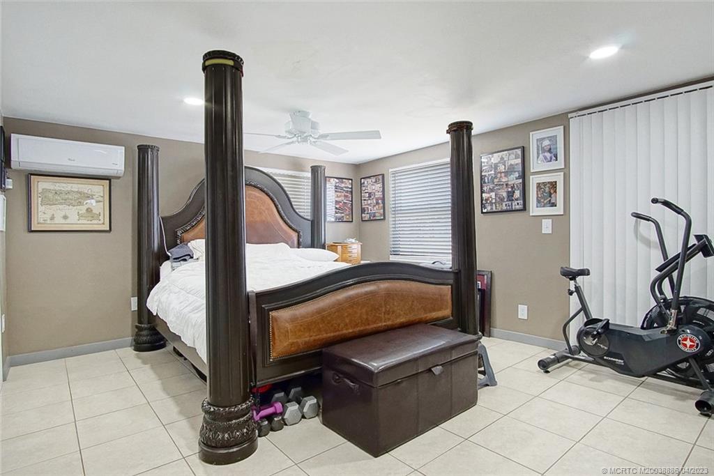 2409 Elizabeth Avenue Fort Pierce, FL 34981 - Photo 12 of 30 a bedroom with bed and glass door