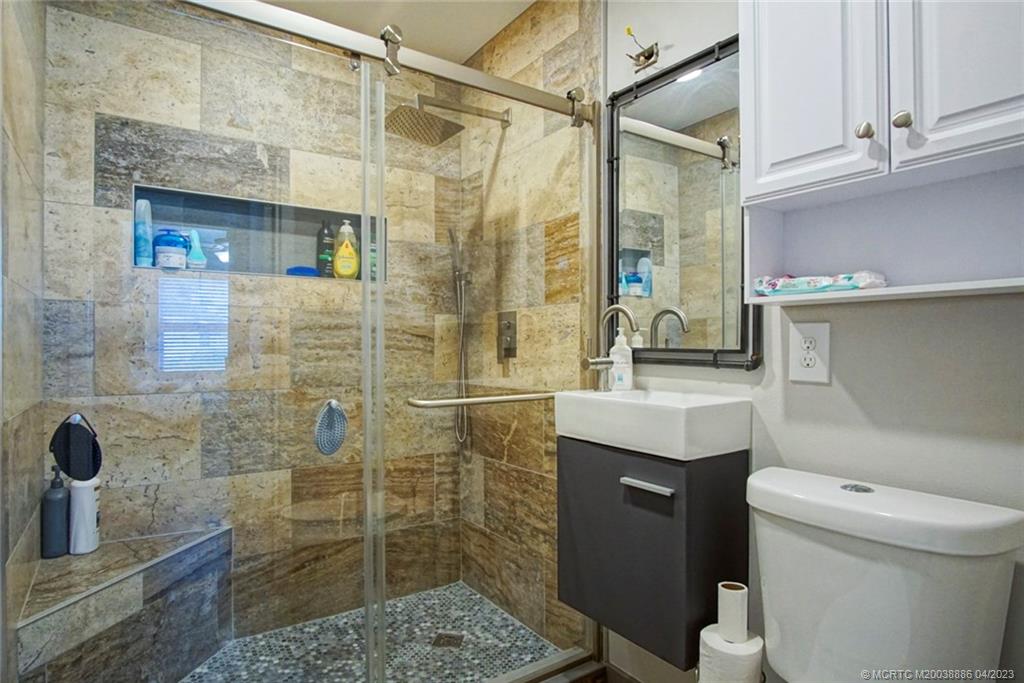 2409 Elizabeth Avenue Fort Pierce, FL 34981 - Photo 14 of 30 a bathroom with a sink a toilet and shower