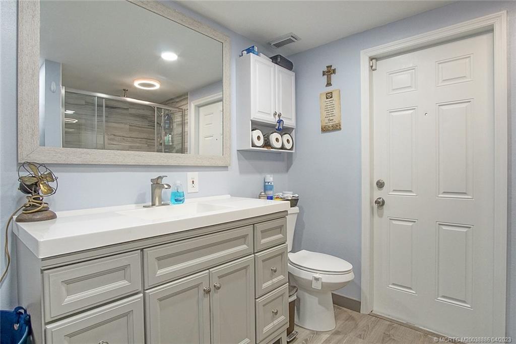2409 Elizabeth Avenue Fort Pierce, FL 34981 - Photo 15 of 30 a bathroom with a sink a toilet and a mirror