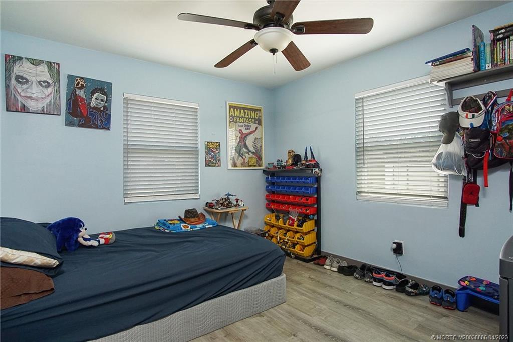 2409 Elizabeth Avenue Fort Pierce, FL 34981 - Photo 17 of 30 a bedroom with a bed and wooden floor