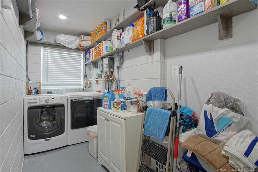 2409 Elizabeth Avenue Fort Pierce, FL 34981 - Photo 19 of 30 a utility room with dryer washer and a view of living room