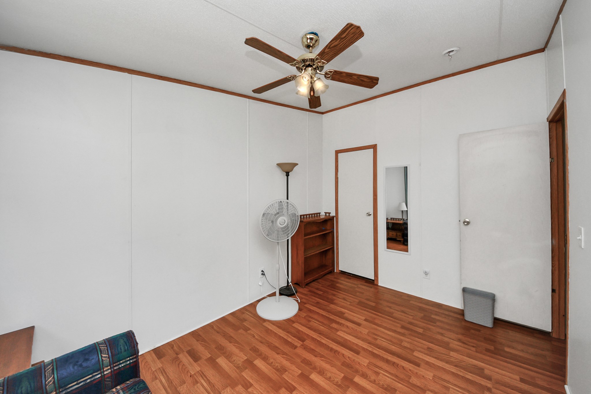 16338 Hill Country Court Conroe, TX 77302 - Photo 11 of 39 a view of a livingroom with a hardwood floor and a ceiling fan