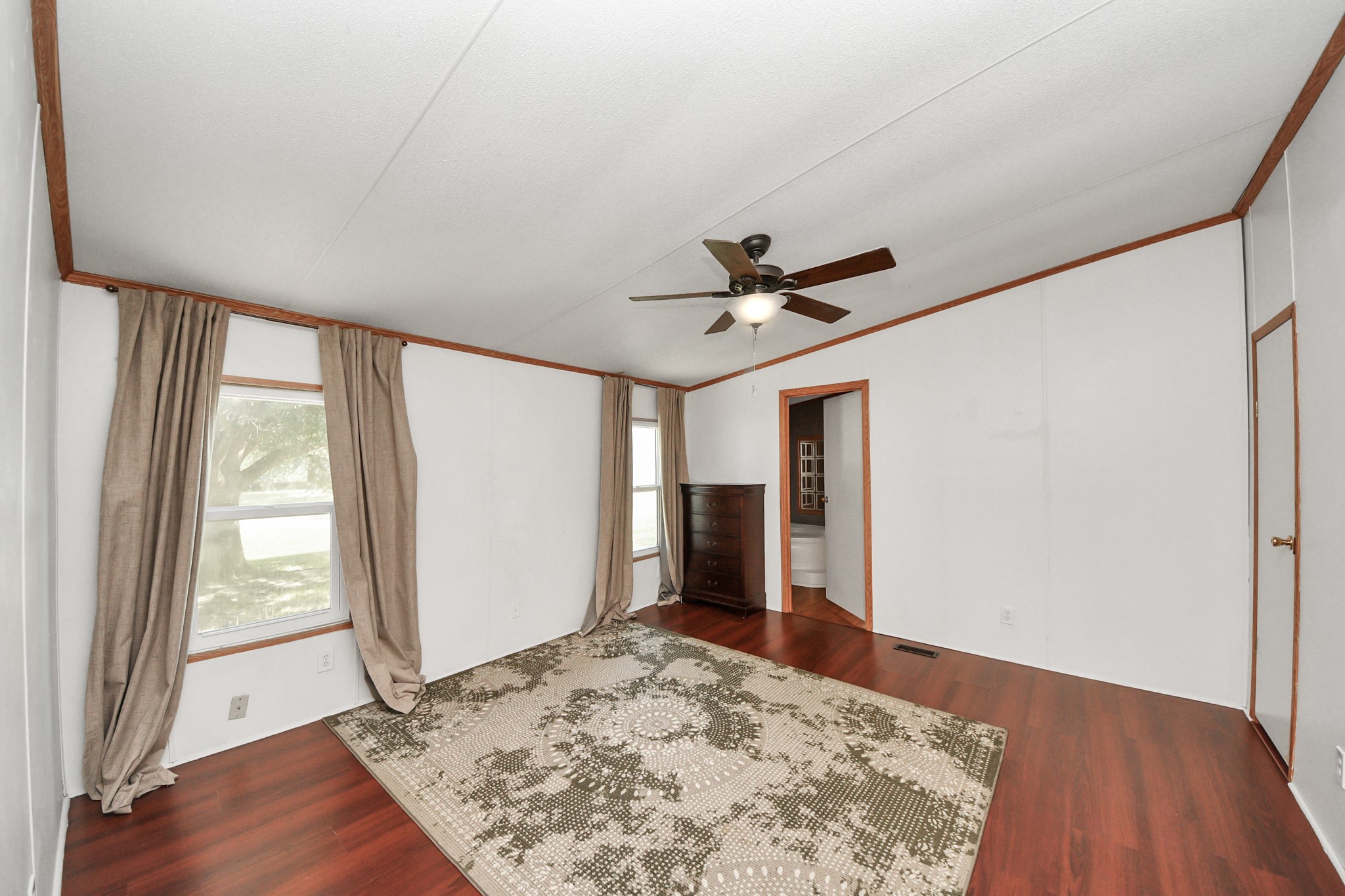 16338 Hill Country Court Conroe, TX 77302 - Photo 15 of 39 a view of a livingroom with wooden floor and a ceiling fan