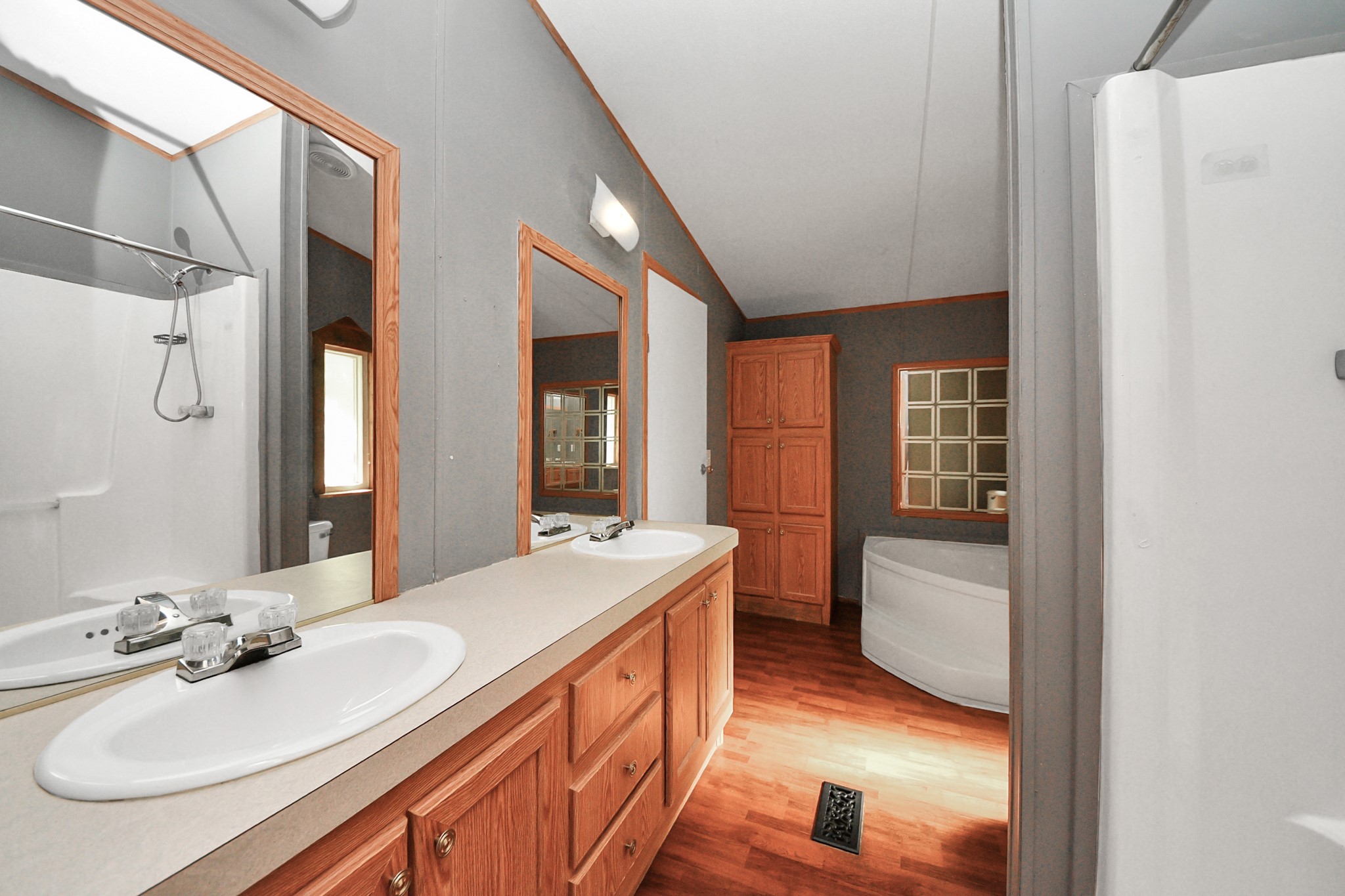 16338 Hill Country Court Conroe, TX 77302 - Photo 17 of 39 a en suite bathroom with a double vanity sink a mirror and a shower