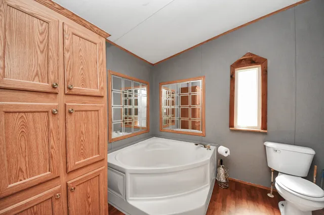 a en suite bathroom with a double vanity sink and a mirror
