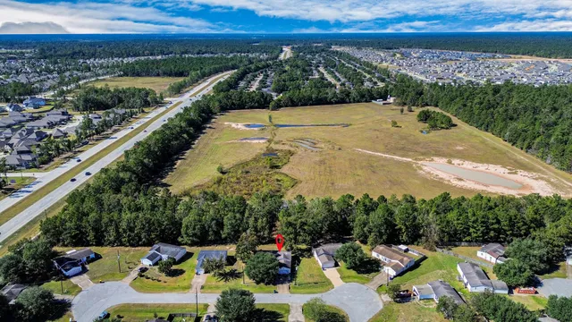 a view of a swimming pool with a patio and a yard