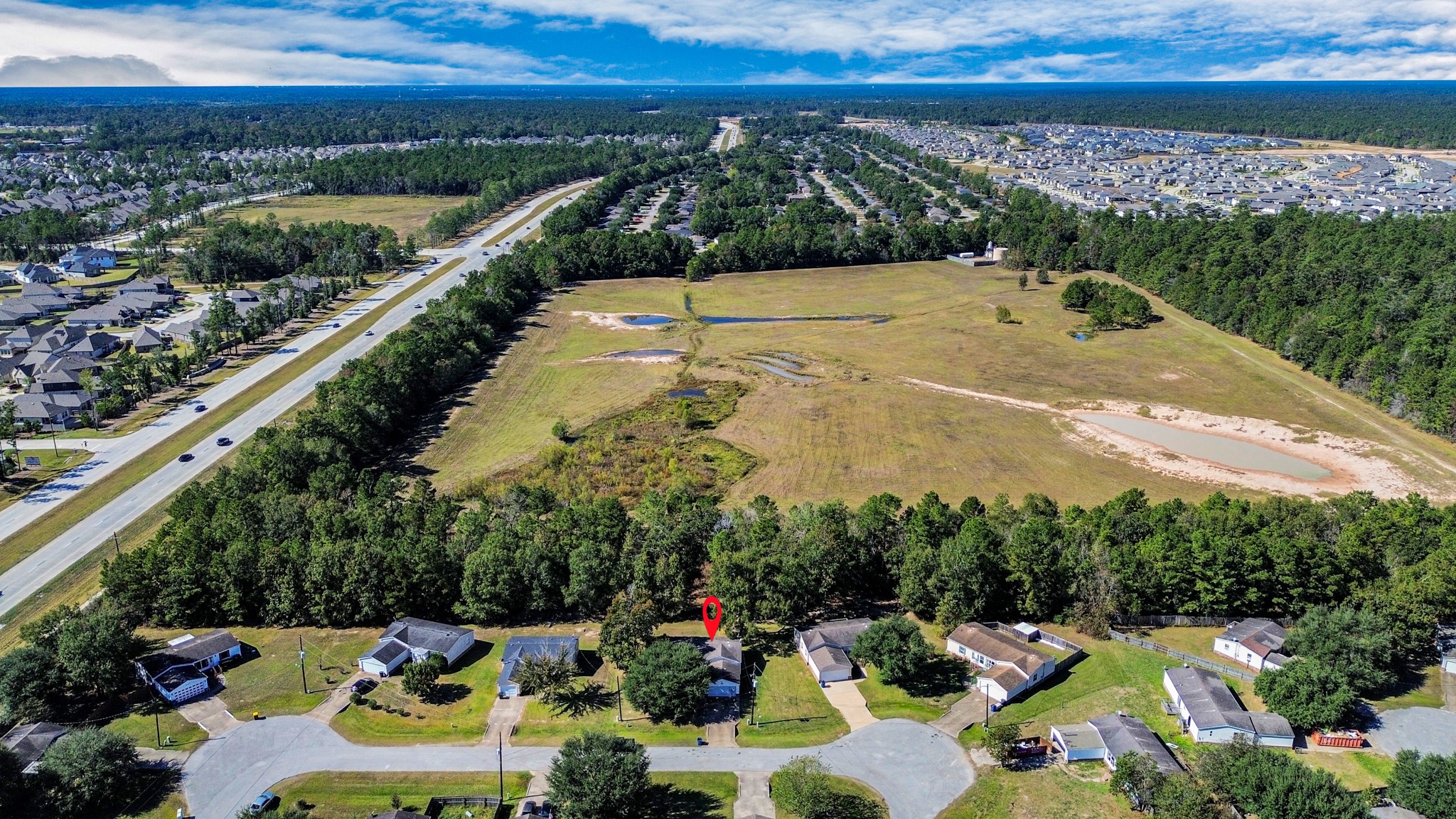16338 Hill Country Court Conroe, TX 77302 - Photo 2 of 39 a view of a swimming pool with a patio and a yard