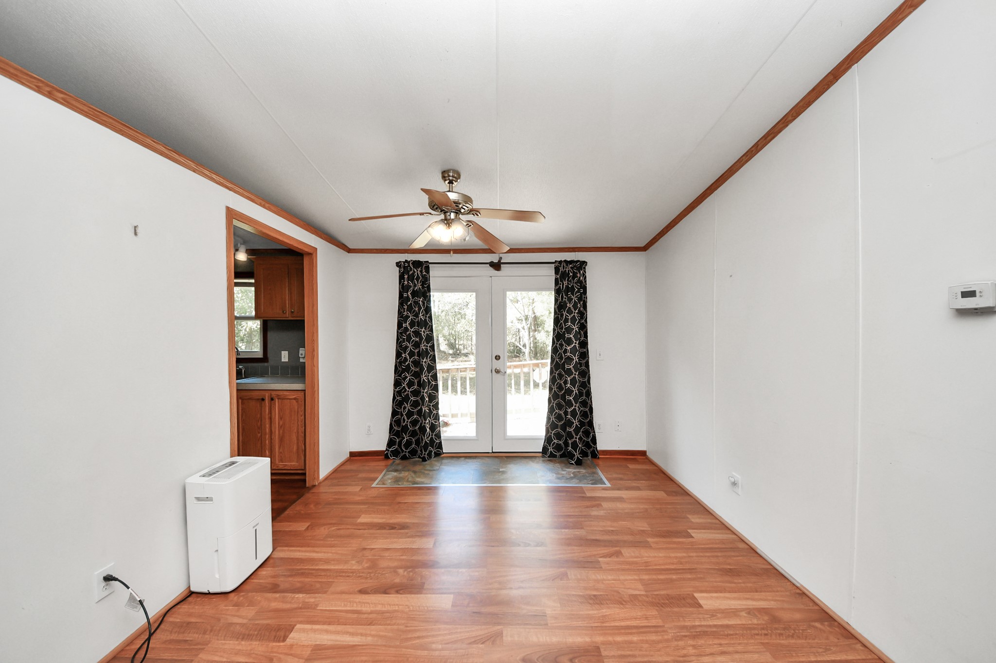 16338 Hill Country Court Conroe, TX 77302 - Photo 22 of 39 a view of an empty room with window and wooden floor