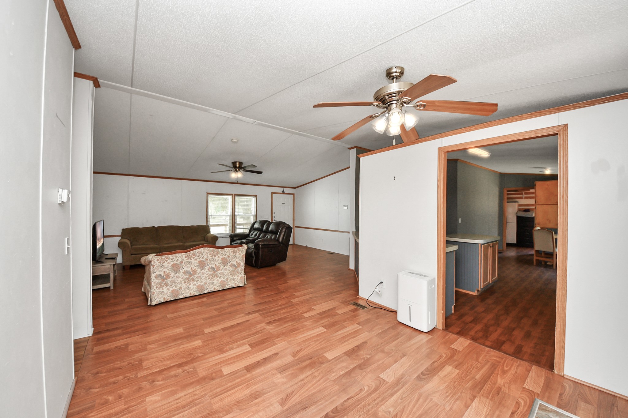 16338 Hill Country Court Conroe, TX 77302 - Photo 23 of 39 a living room with furniture and a chandelier