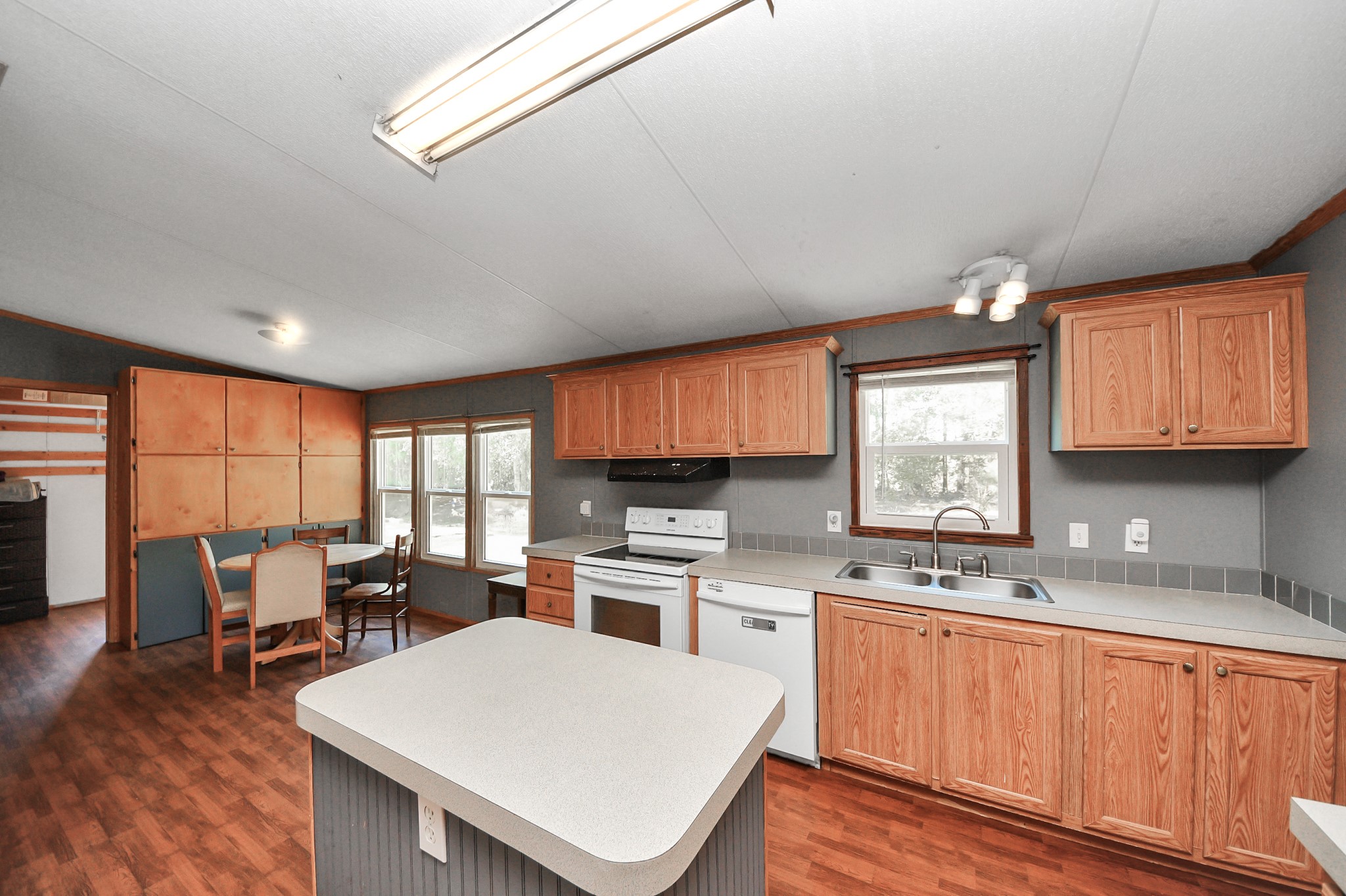 16338 Hill Country Court Conroe, TX 77302 - Photo 26 of 39 a kitchen with a sink a stove cabinets and wooden floor