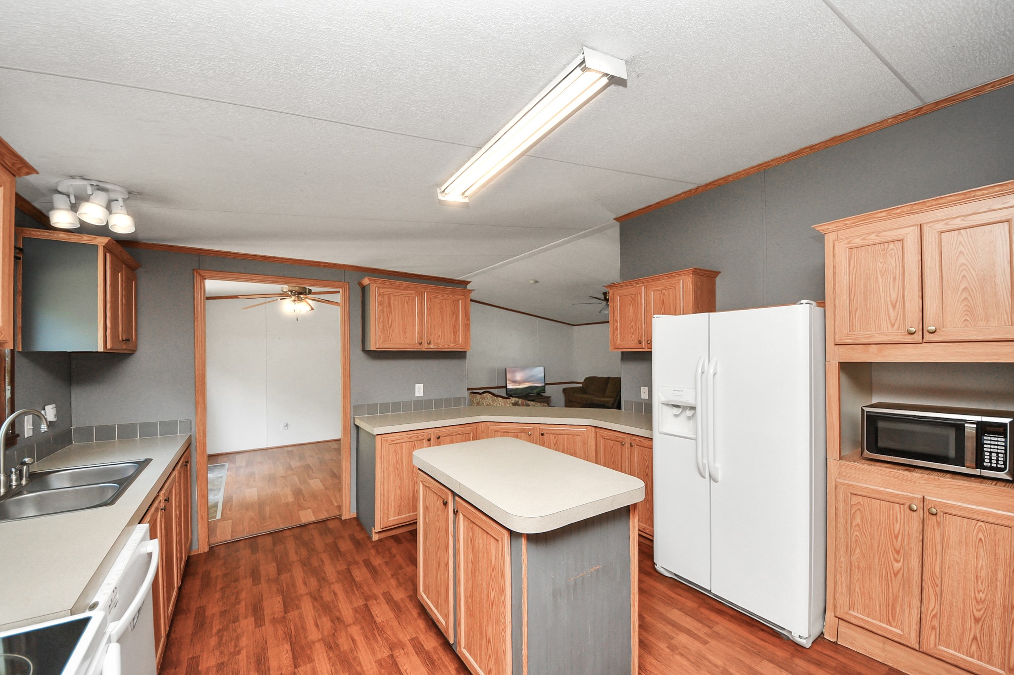 16338 Hill Country Court Conroe, TX 77302 - Photo 29 of 39 a kitchen that has a sink a stove a refrigerator and a stove top oven