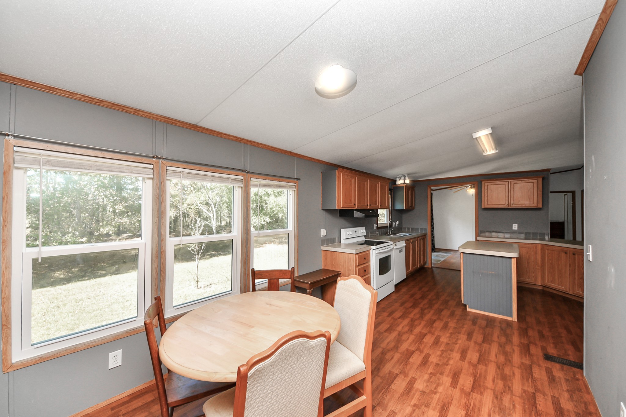 16338 Hill Country Court Conroe, TX 77302 - Photo 31 of 39 a large kitchen with a table chairs wooden floor and stainless steel appliances
