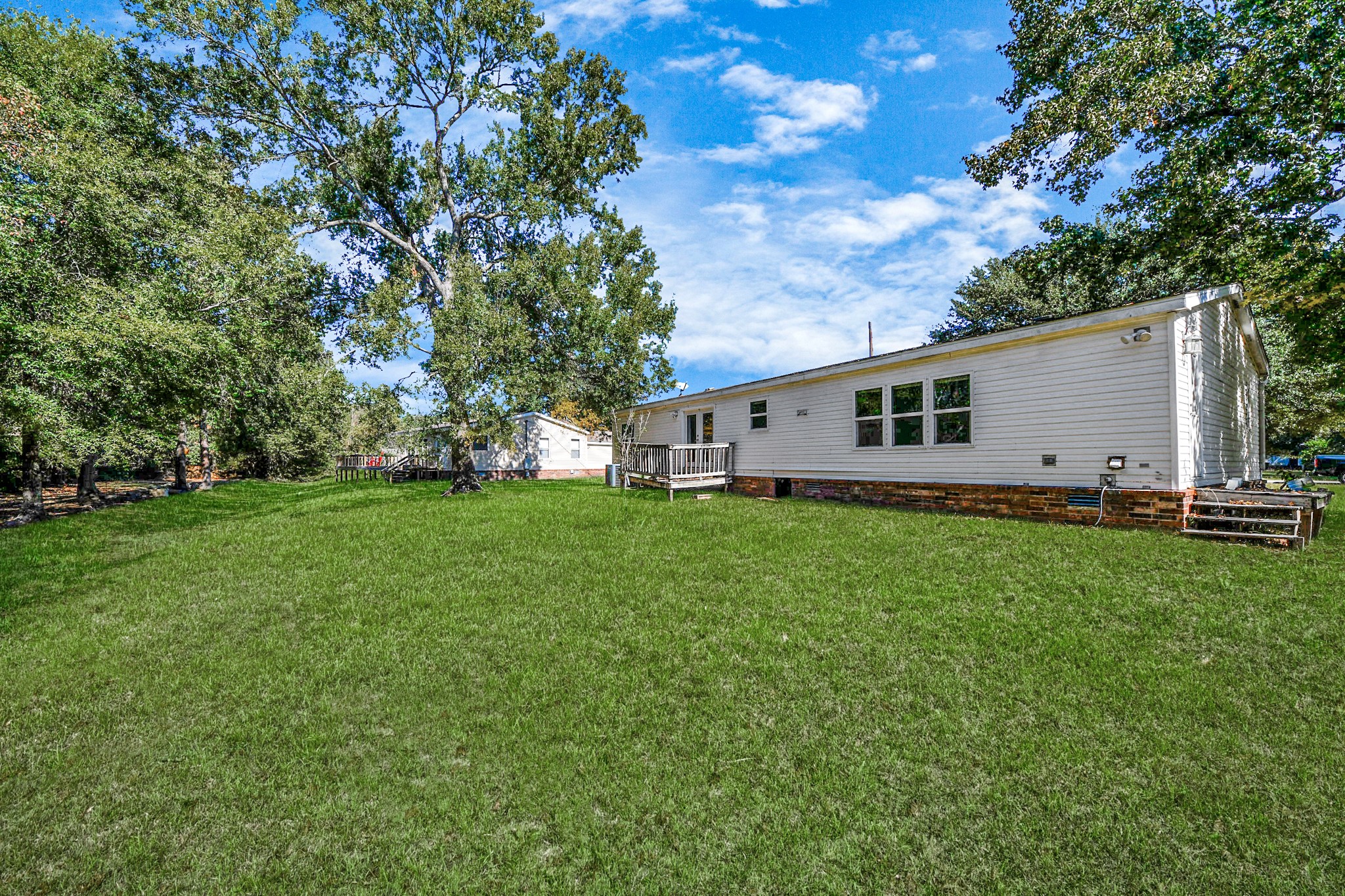 16338 Hill Country Court Conroe, TX 77302 - Photo 33 of 39 a view of a backyard with plants and large trees