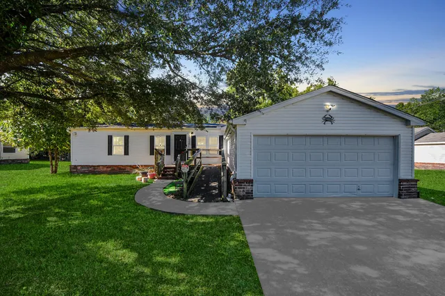 a front view of house with yard and green space