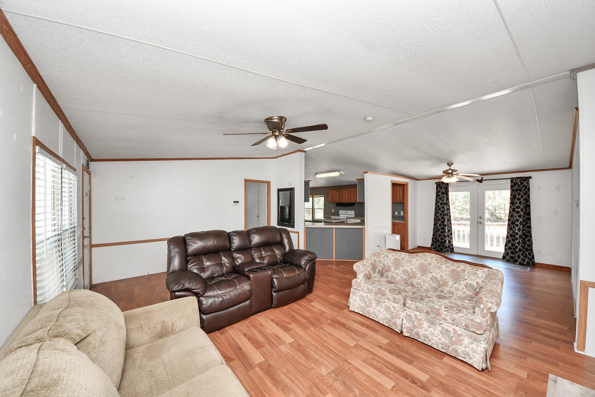 16338 Hill Country Court Conroe, TX 77302 - Photo 7 of 39 a living room with furniture window and a ceiling fan