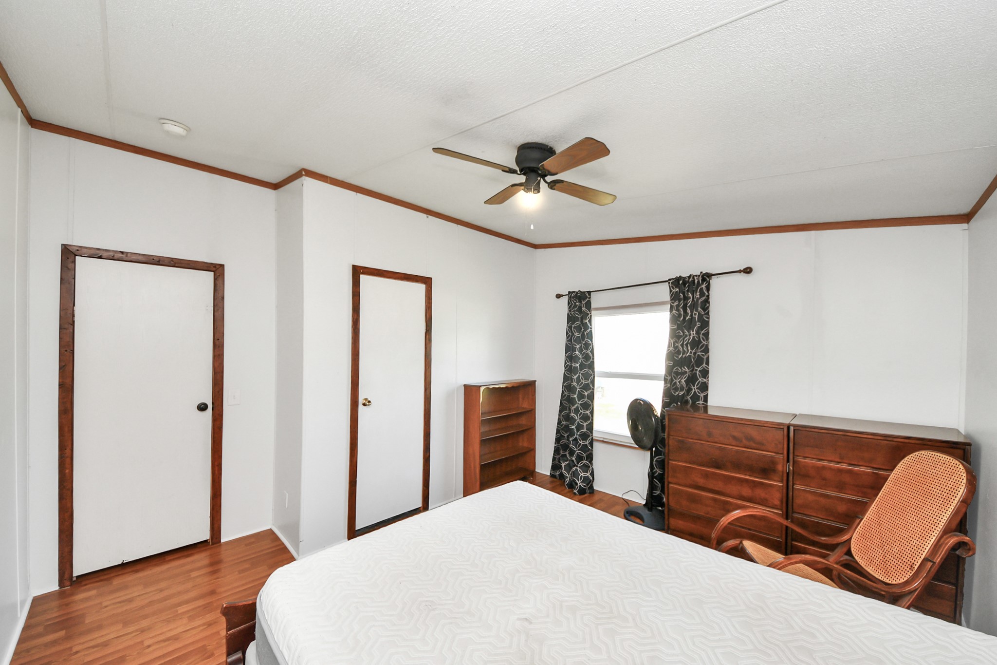 16338 Hill Country Court Conroe, TX 77302 - Photo 9 of 39 a bedroom with a bed and a dresser with wooden floor