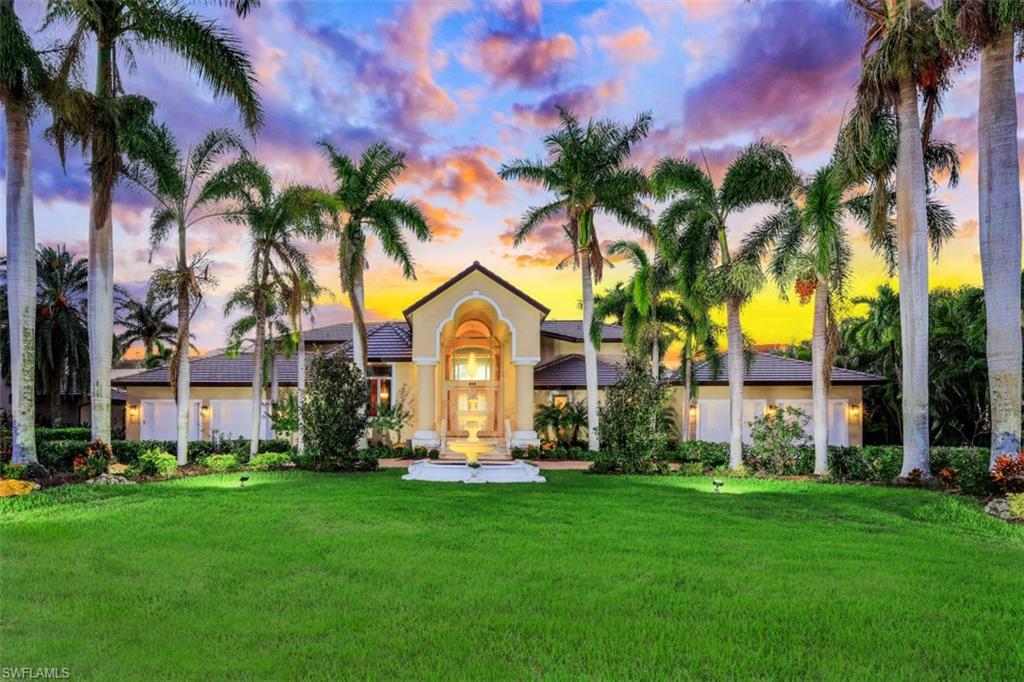856 Inlet Drive Marco Island, FL 34145 - Photo 1 of 35 a front view of a house with a garden