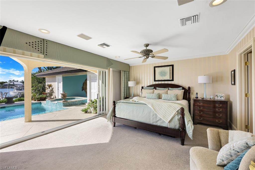 856 Inlet Drive Marco Island, FL 34145 - Photo 13 of 35 a spacious bedroom with a bed and glass door