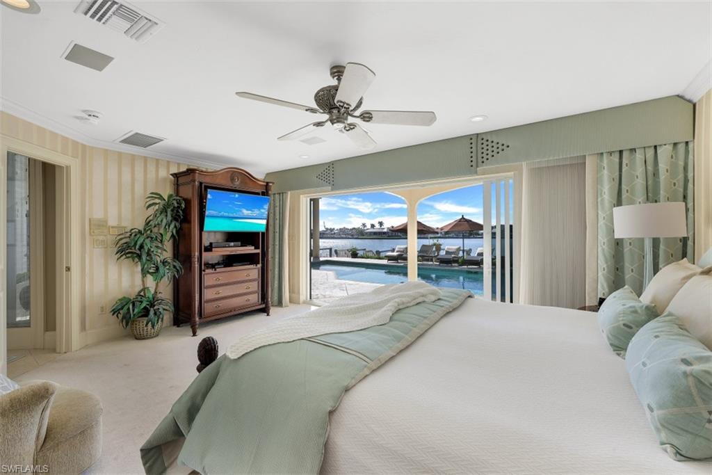 856 Inlet Drive Marco Island, FL 34145 - Photo 14 of 35 a bedroom with a bed and a large window