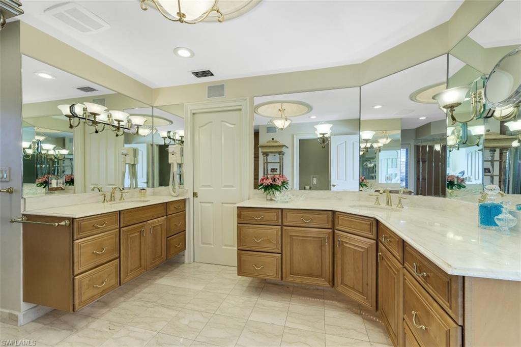 856 Inlet Drive Marco Island, FL 34145 - Photo 15 of 35 a large kitchen with a sink and a large mirror