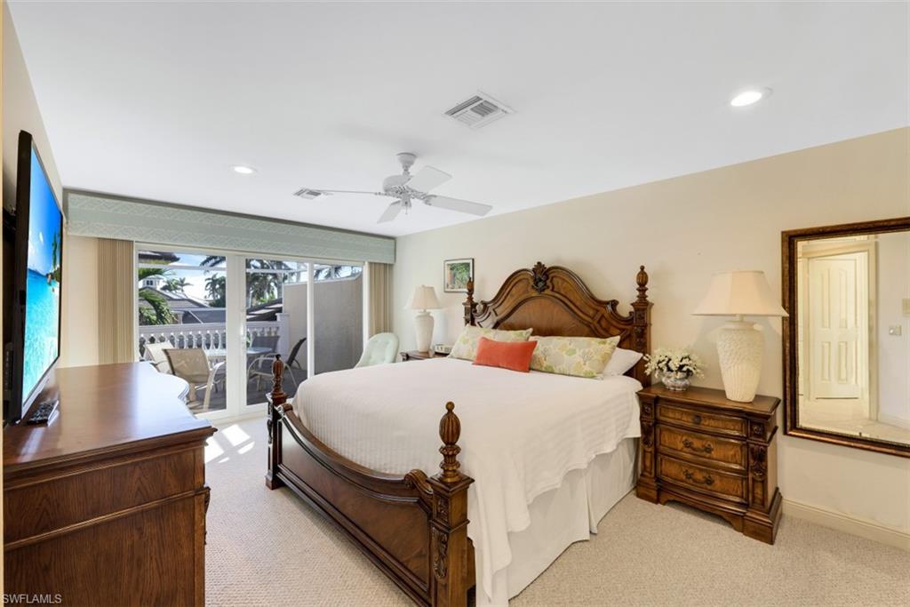 856 Inlet Drive Marco Island, FL 34145 - Photo 16 of 35 a bedroom with a bed a couch and dresser